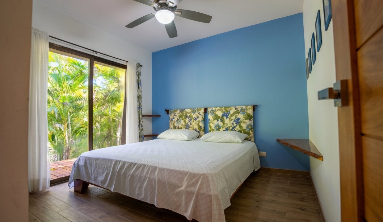 Tropical Eden — bedroom blue accent wall
