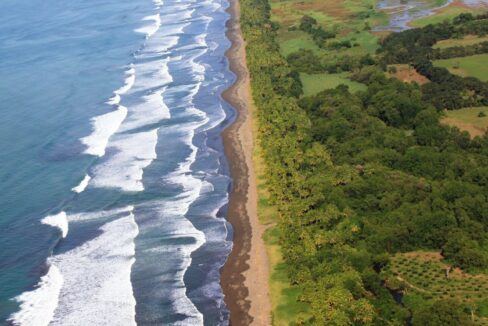 Aerial of the long surf line along Playa El Rey on Costa Rica's South Pacific coast