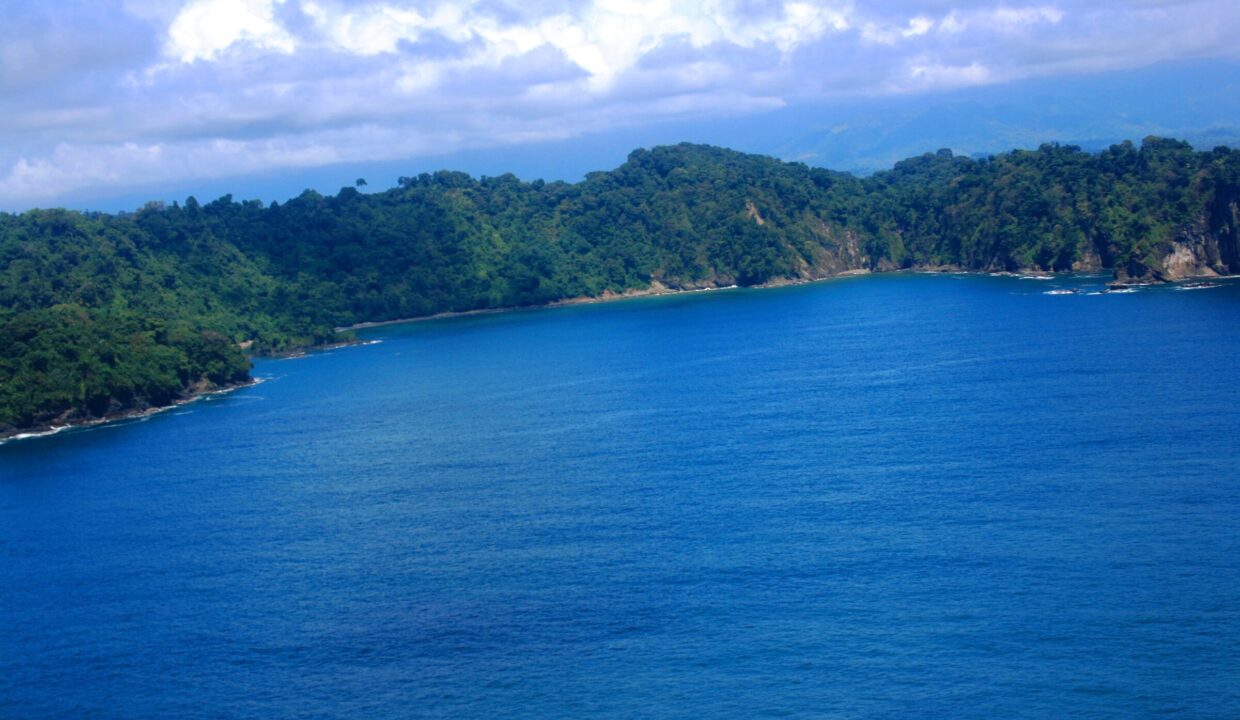 Deep-blue Pacific bay wrapped by green headlands near Quepos, Costa Rica