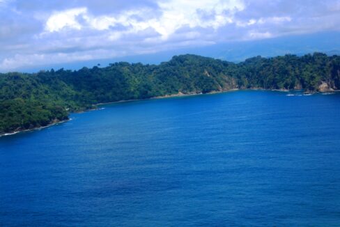 Deep-blue Pacific bay wrapped by green headlands near Quepos, Costa Rica