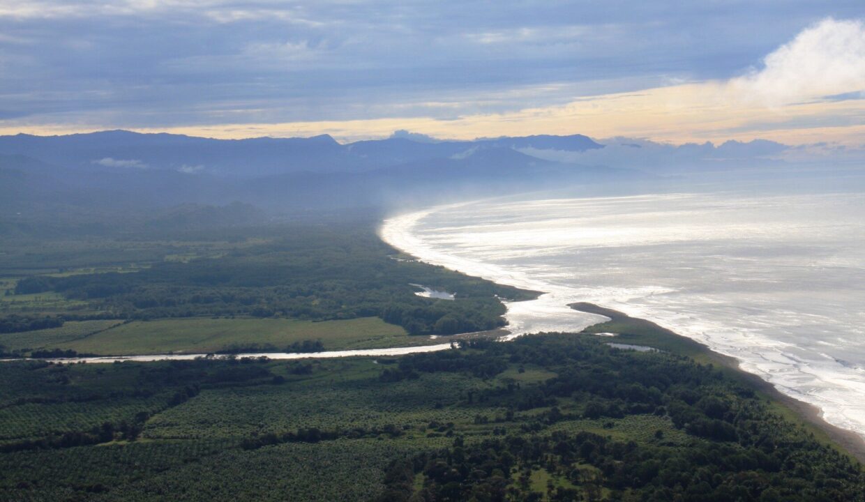 Long Pacific beach curving into golden-hour light near Playa El Rey, Costa Rica