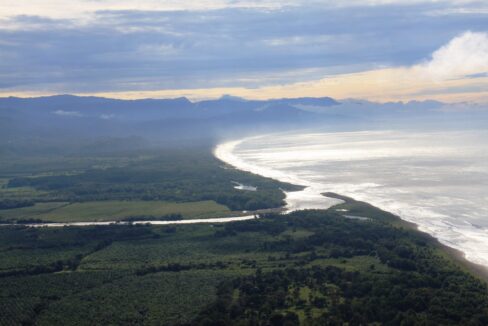 Long Pacific beach curving into golden-hour light near Playa El Rey, Costa Rica