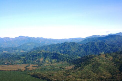 Blue Talamanca mountain range rising behind the coastal plains, South Pacific Costa Rica