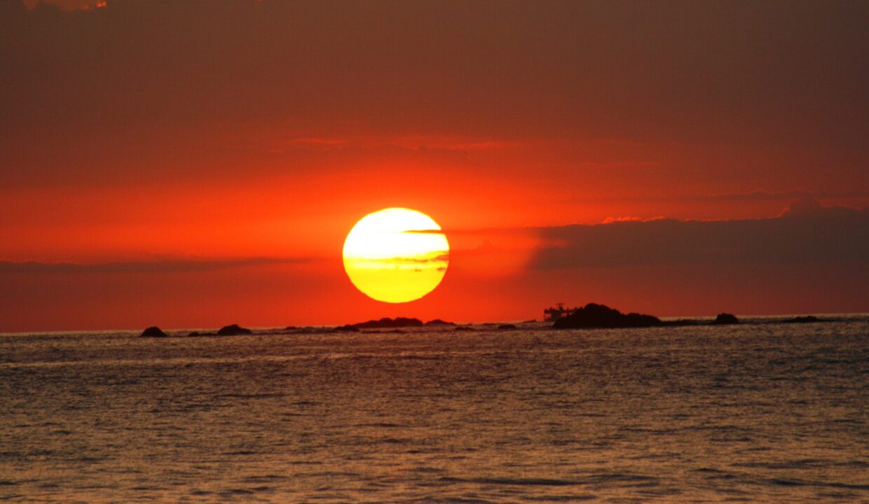 Dramatic red sun setting over the Pacific from the South Pacific coast of Costa Rica