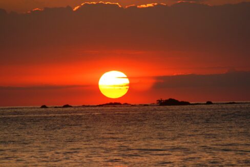 Dramatic red sun setting over the Pacific from the South Pacific coast of Costa Rica
