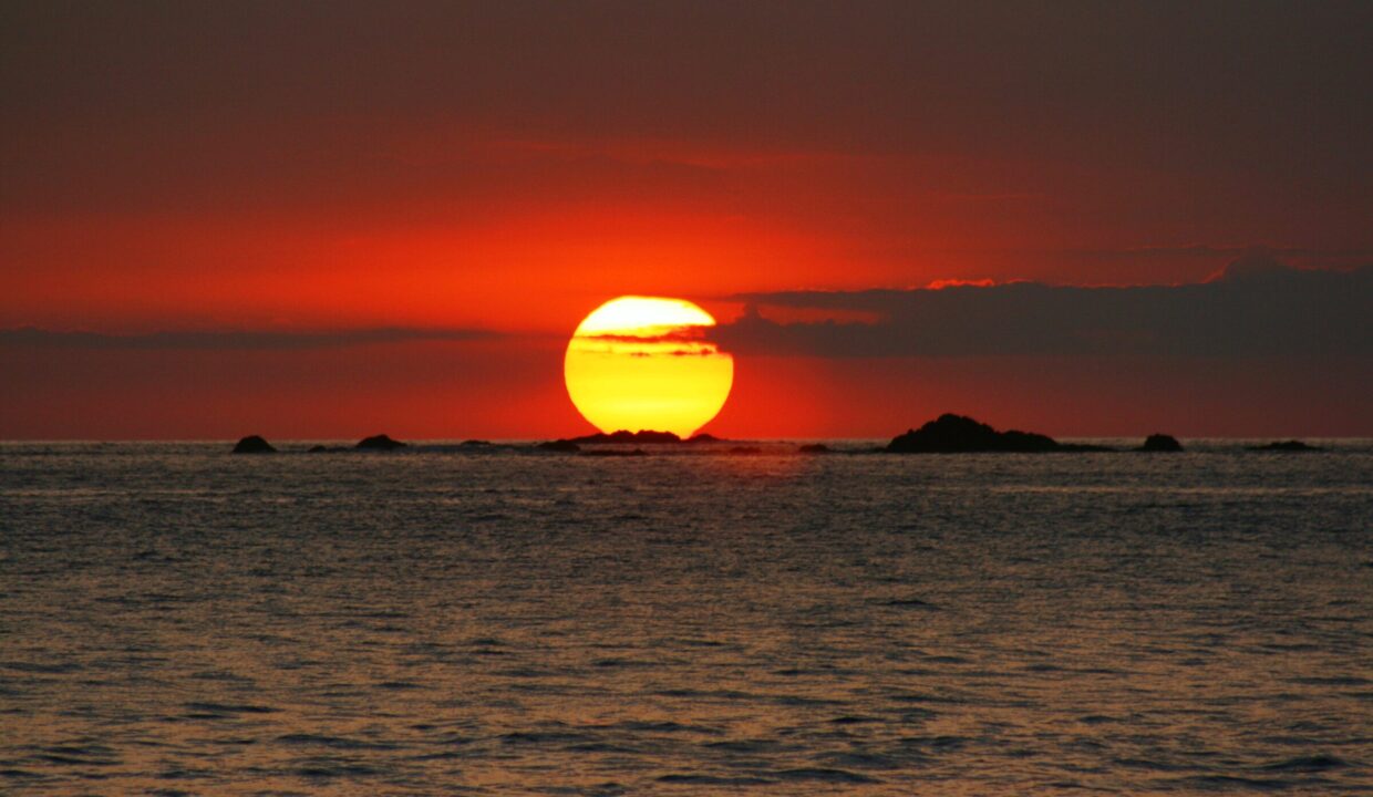 Golden-red Pacific sunset over the ocean near Playa El Rey, Quepos, Costa Rica