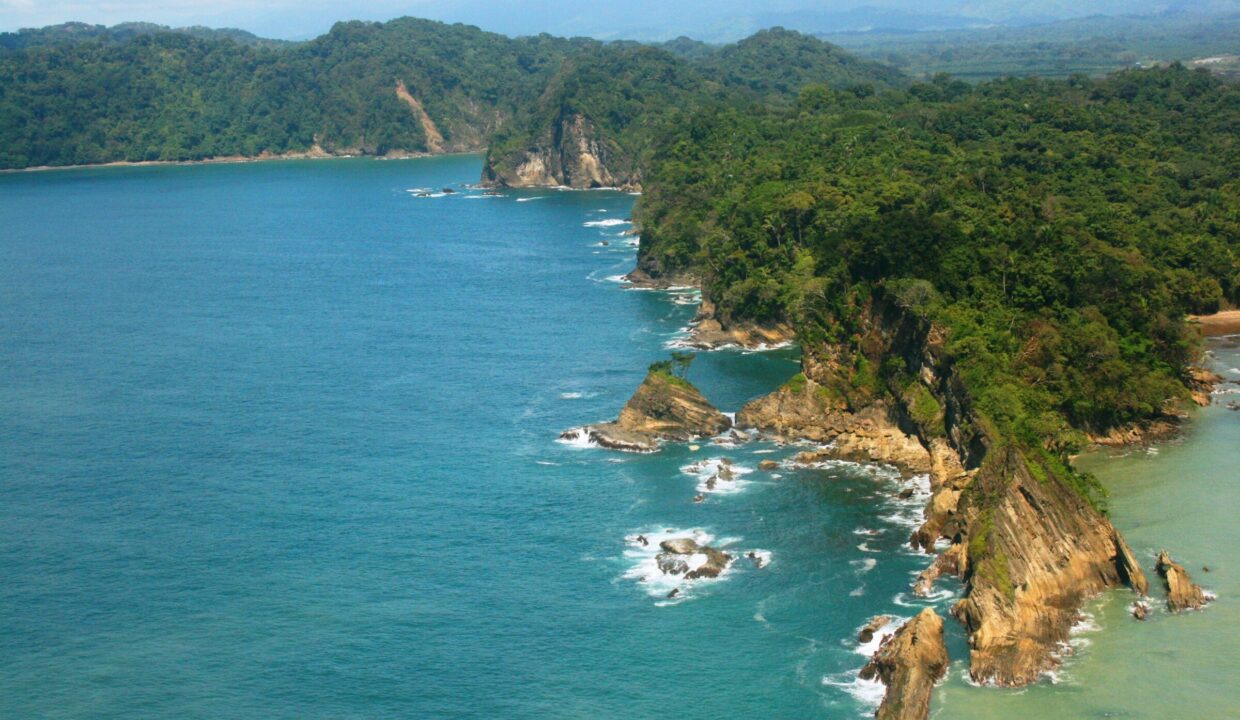 Turquoise Pacific bay and rainforest shoreline near Quepos, Costa Rica